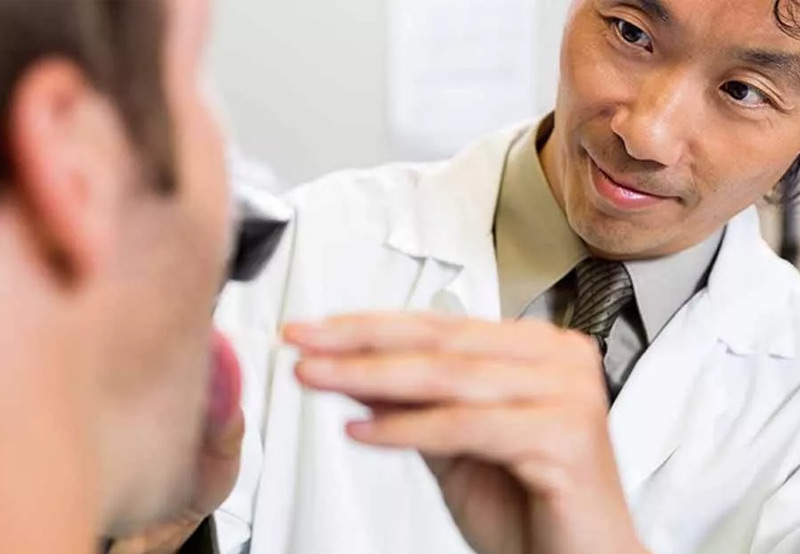 Specialist-examining-patient-for-nasopharyngeal-cancer